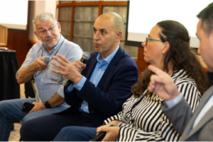Four people in a row speaking